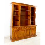 An impressive book case in two parts and excellent condition, the lower part with four drawers and