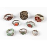 A collection of eight ancient and later rings, bronze and other materials, partly with red gemstones