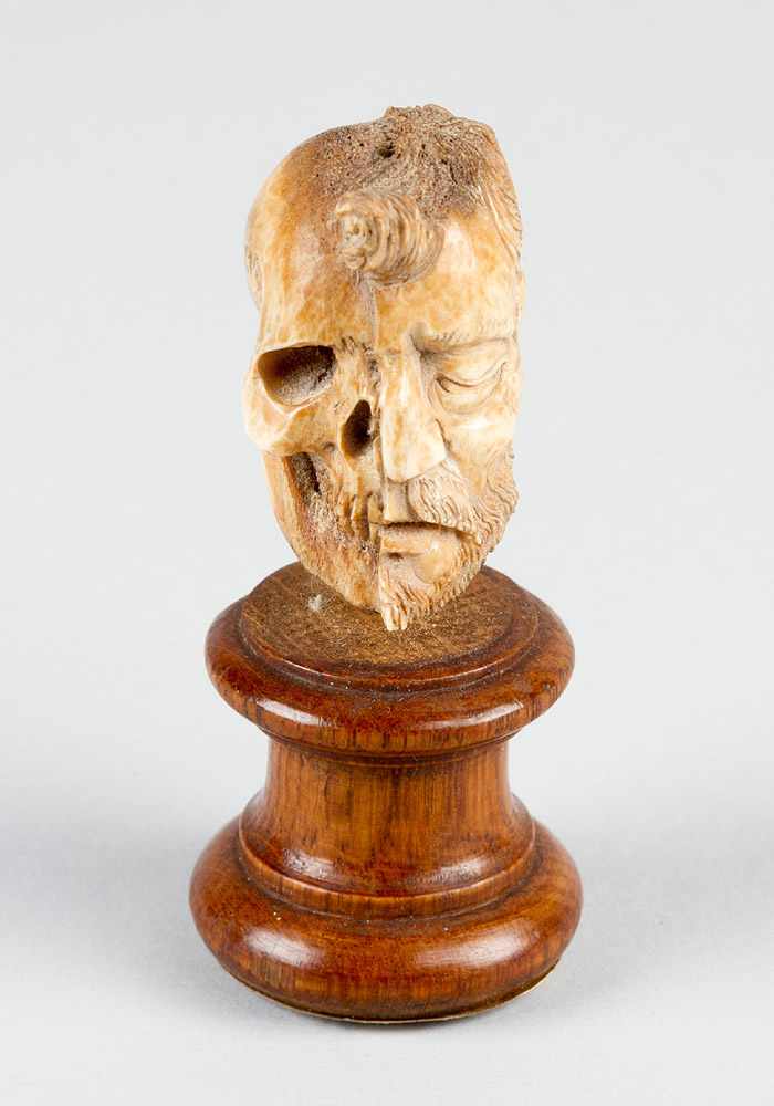 Memento Mori of a face half men and skull, very fine bone carving in manieristic manner, on turned