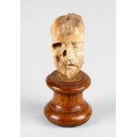 Memento Mori of a face half men and skull, very fine bone carving in manieristic manner, on turned