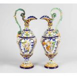 A pair of large Italian Majolica jugs, with central field, shaped and waved body; thin neck and