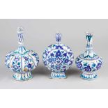 Three Islamic ceramic containers in different shapes, with blue and turquoise paint on white ground,