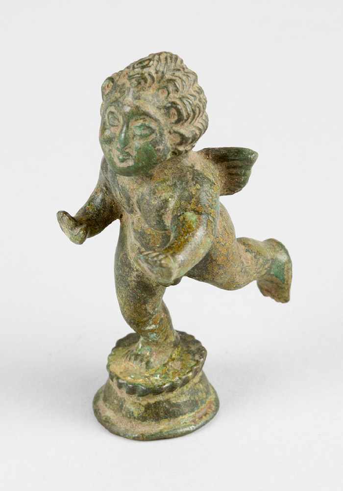 A small bronze sculpture of Cupido with wings, on round integrated base; full bronze cast with