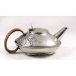 A Liberty Tudric teapot number 0231 of squat form with foliage decoration.
