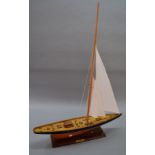 A large wooden ship model. Plaque reads "Shamrock. America's Cup". 125cm tall.
