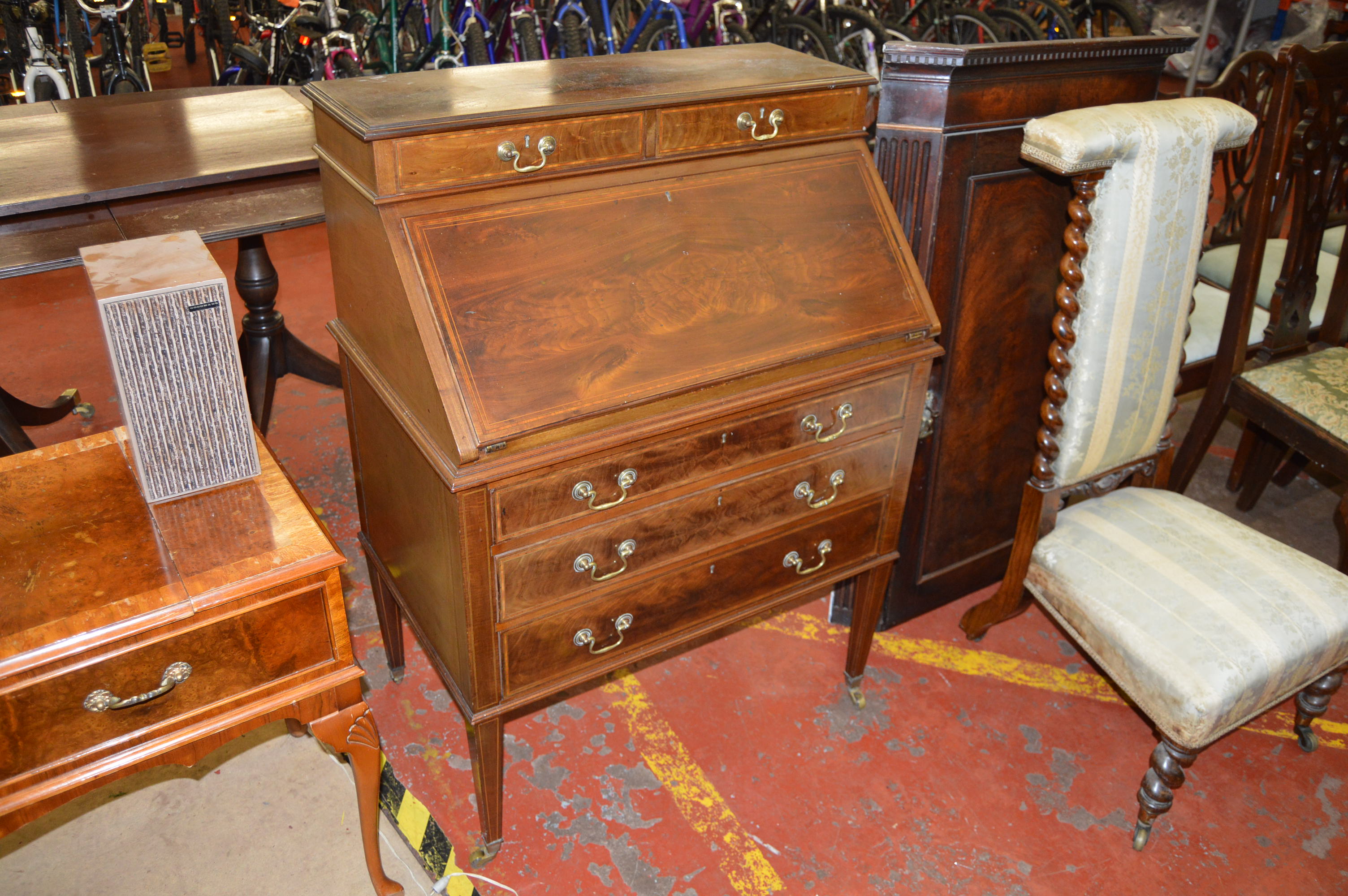 An Edwardian mahogany bureau fitted as a writing desk