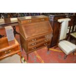 An Edwardian mahogany bureau fitted as a writing desk