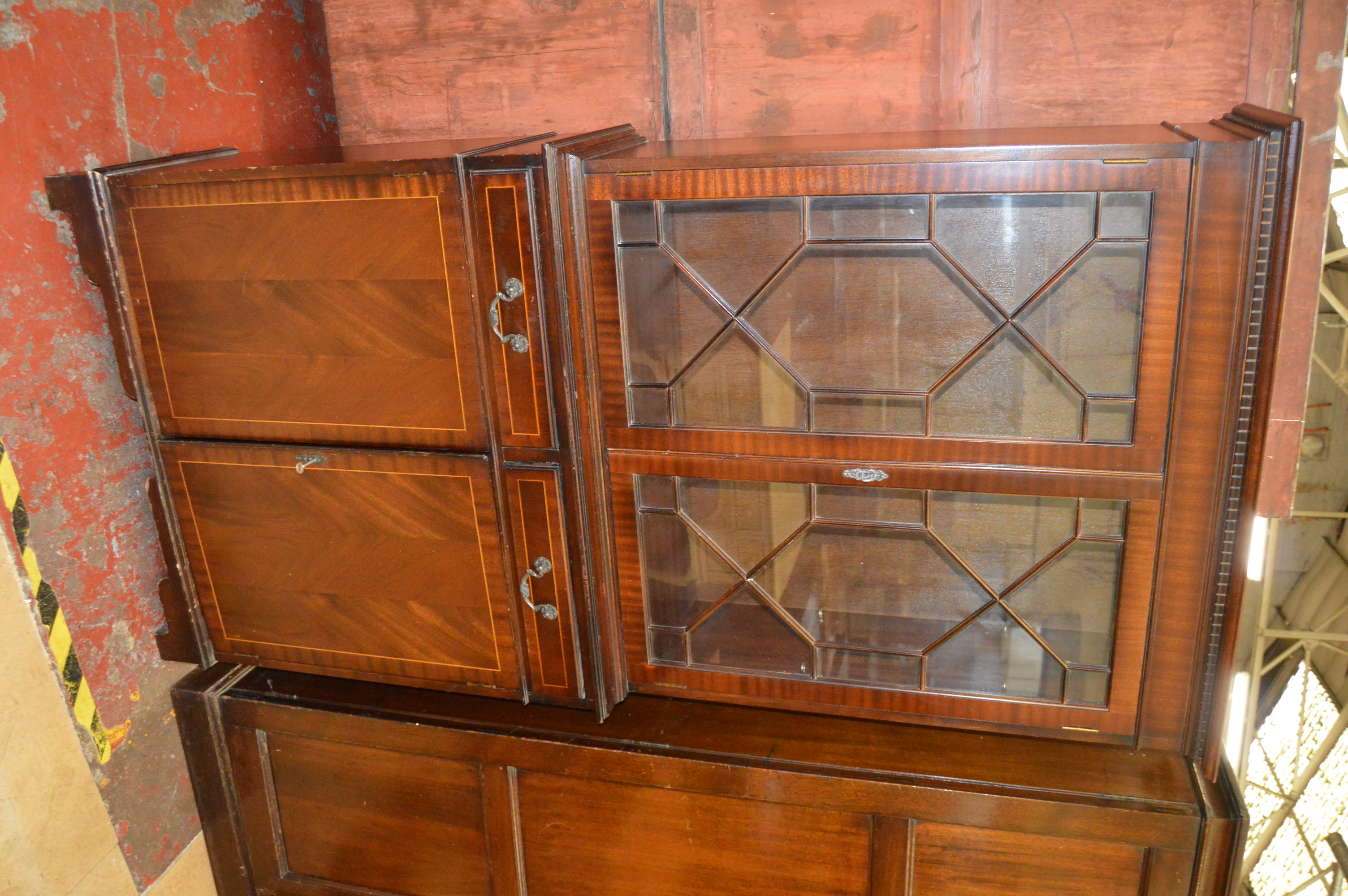 A tall reproduction mahogany bookcase with cupboard below and Astragal glazed doors above