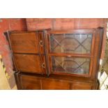 A tall reproduction mahogany bookcase with cupboard below and Astragal glazed doors above