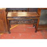 An interesting colonial style hardwood side table with heavily carved frieze