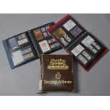 2 stamp albums containing various presentation packs and assorted stamps