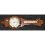 An oak cased Aneroid Barometer with thermometer.