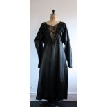 1930s black, satin dress with intricate lace and beaded v-neckline detail.