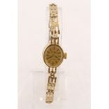 A modern ladies 9ct quartz wristwatch with fixed gold bracelet, gross weight 9.