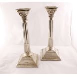 A pair of silver Corinthian column candlesticks with sconces, 250mm high & filled,