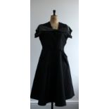1950a black rayon taffeta dress. Features a lurex fine knit collar and sleeve detail.