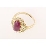 A modern cabochon ruby & diamond cluster ring, diamond weight approx 0.