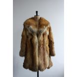 1970s Red Fox fur 3/4 length coat by Harrisons of Worcester and Luton. Wide lapels, leather binding.