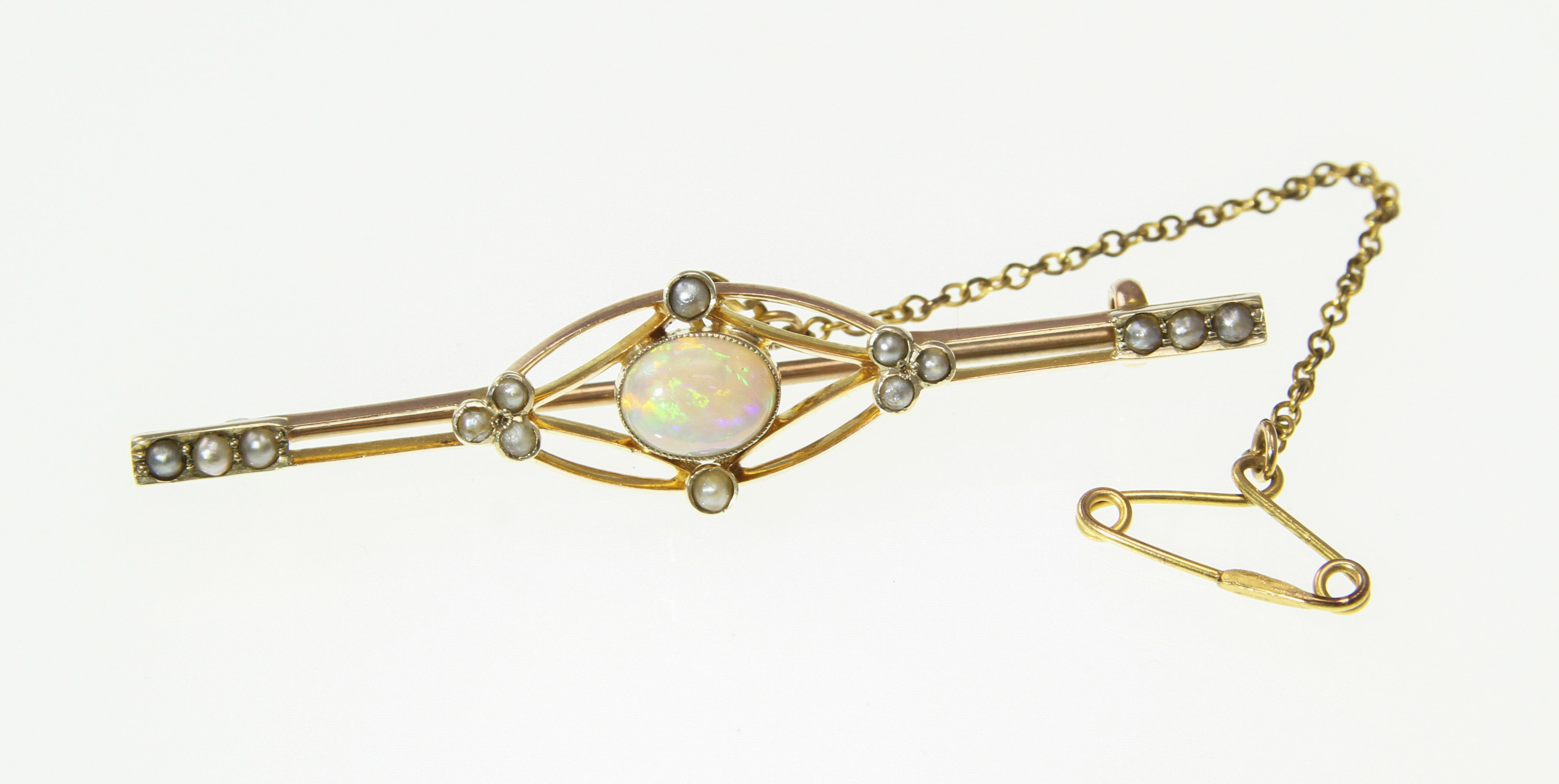 An opal and seed-pearl set bar brooch stamped 9ct