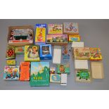 Twenty four boxed novelty toys of tinplate and plastic construction, many of Chinese origin.