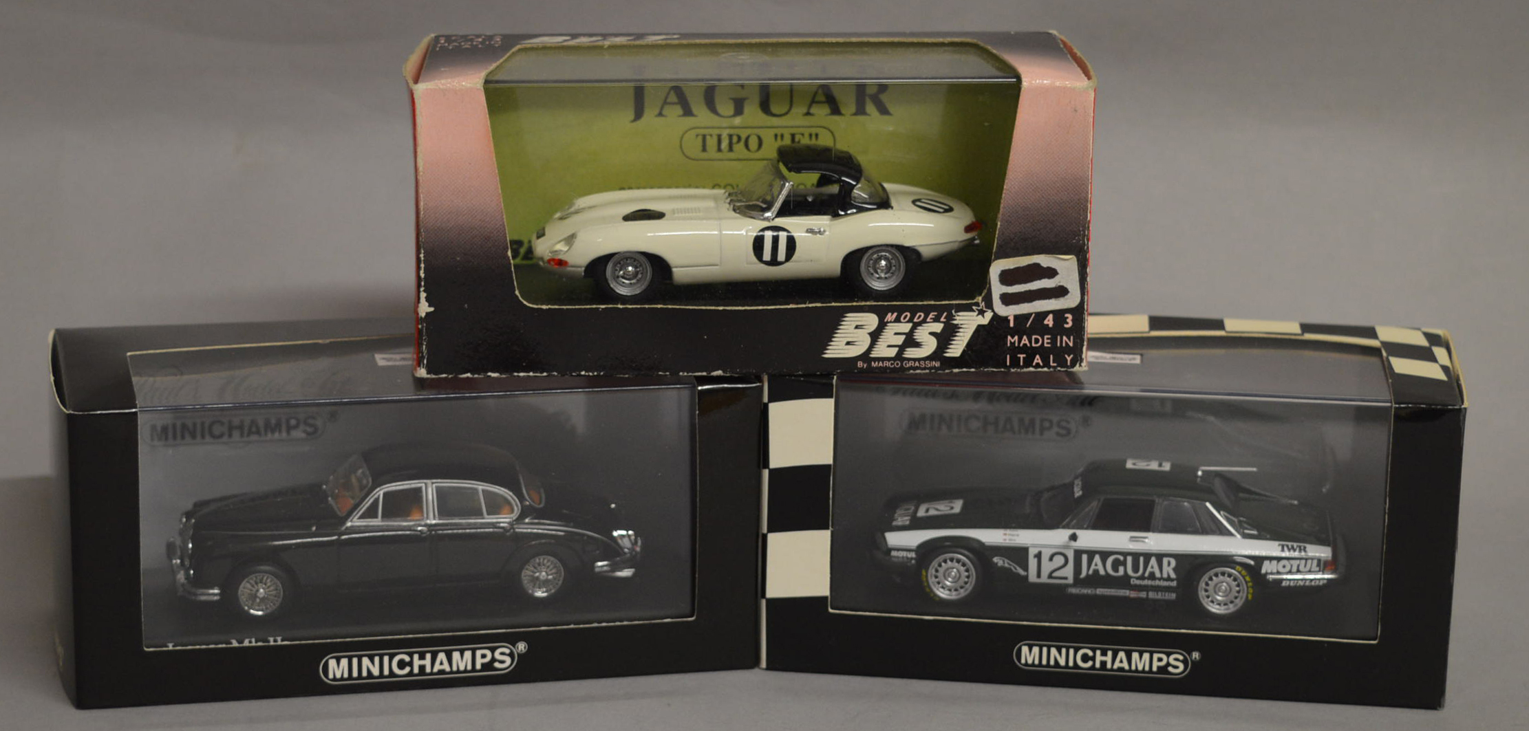 Three boxed Jaguar diecast model cars in 1:43 scale,