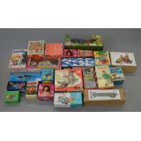 Twenty two boxed novelty toys of tinplate and plastic construction, many of Chinese origin.
