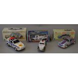 Three boxed battery operated toy cars of tinplate and plastic construction,