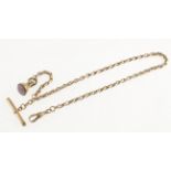 A Victorian rose-gold long albert chain with end tab marked 9c,