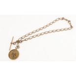 A 9ct rose-gold double albert chain with attached football fob medal,