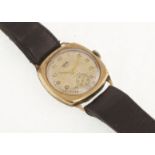 A 1950's 9ct cushion-shaped ENICAR manual-wind wristwatch with fitted leather strap,