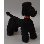 A soft toy Black Poodle (Circa 1920's) with studded collar and glass eyes,