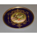 A Royal Worcester gilded plate with raised edges. Central painting signed "L. Flexman".