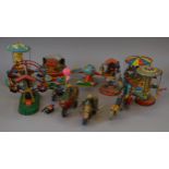 A mixed group of unboxed tinplate toys including a number of clockwork carousels and three