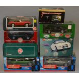Four boxed Corgi MG diecast model cars in 1:18 scale, an MGB in red,