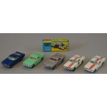 Five Corgi Toys Ford Mustang diecast model cars, including two 325 Competition Models,