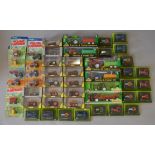 A quantity of boxed and carded diecast model Tractors and other agricultural vehicles by Ertl,