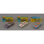 Three boxed Corgi Toys Ford Mustang diecast model cars, 320 in metallic purple,