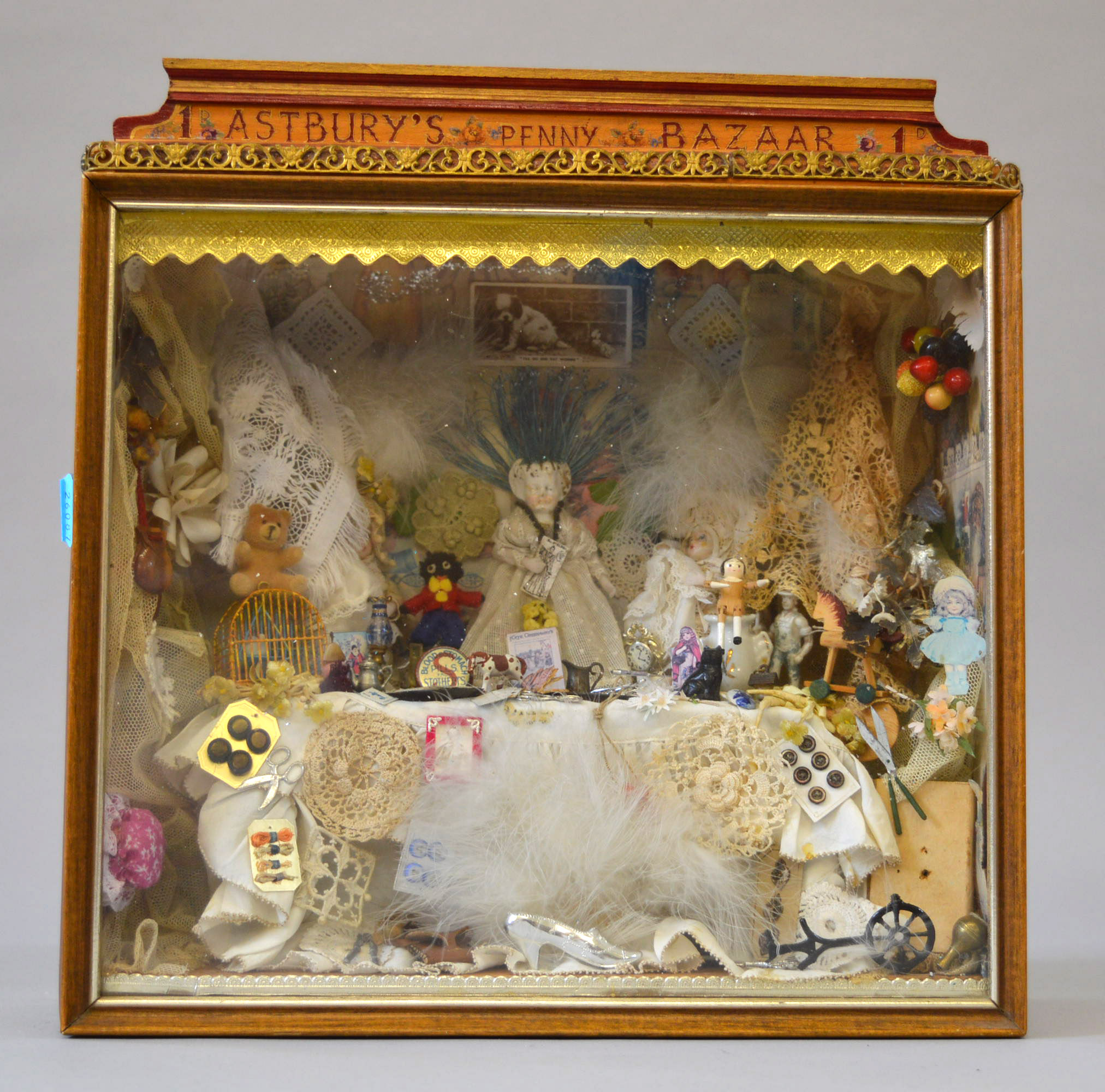 'Astbury's Penny Bazaar' scene in a glass fronted wooden case, includes miniature toys, dolls,