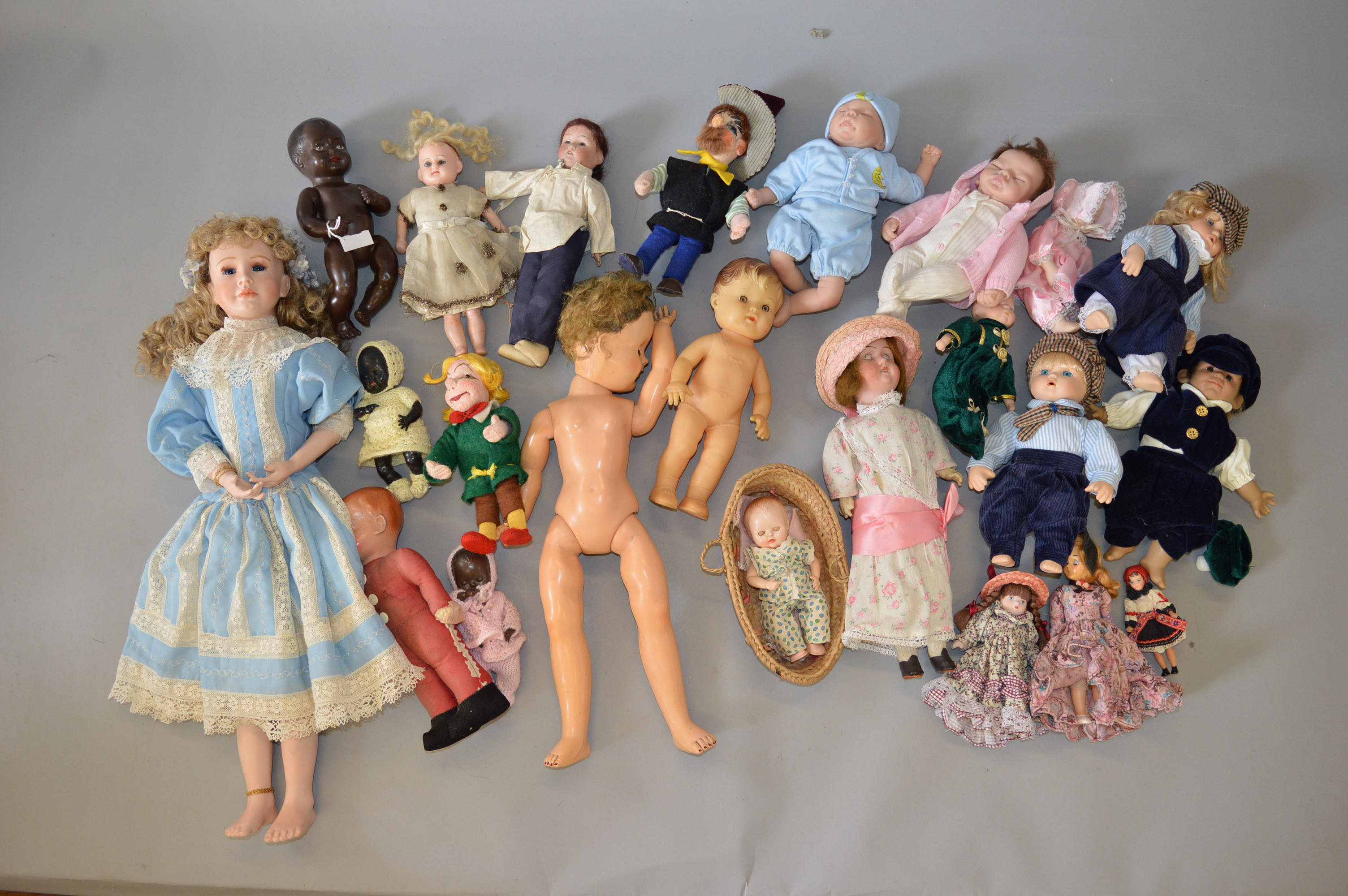 Good quantity of assorted dolls: two cloth dolls with moulded faces and stitched features; wax doll;