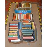 4 Boxes of assorted vintage books including fiction and non fiction.