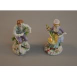 A pair of Sitzendorf Dresden flower figures of a seated man and woman. Woman 12.5cm tall.