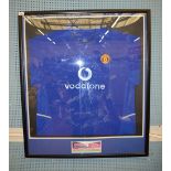 A framed Manchester United FC squad third kit shirt signed by the Manchester United Squad,