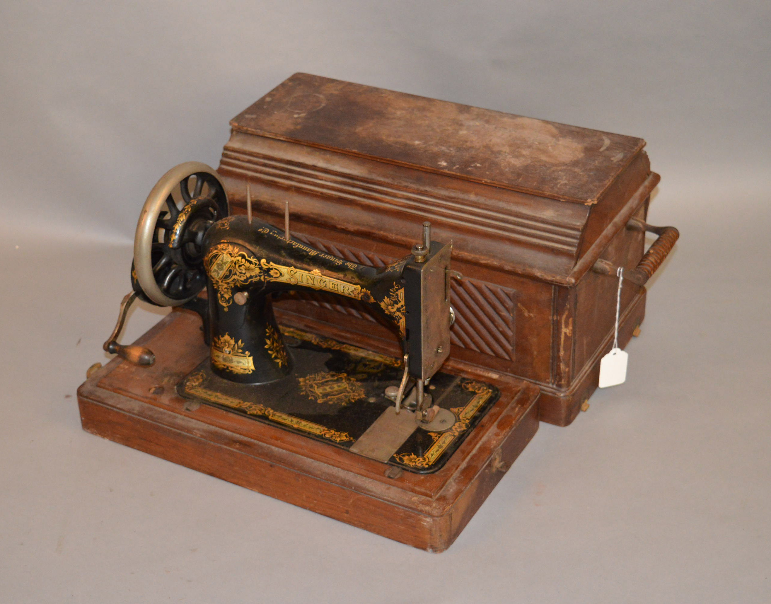 A late Victorian Singer sewing machine in wooden case.