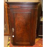 An early 20th century flame mahogany corner cupboard, approx 1metre tall.