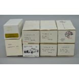 Eight boxed white metal and resin kits, mostly cars in 1:43 scale,