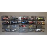 Twenty boxed Quartzo diecast model racing cars in 1:43 scale.