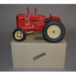 An unboxed vintage Lesney diecast large scale model of a Massey Harris 745D Tractor in red with