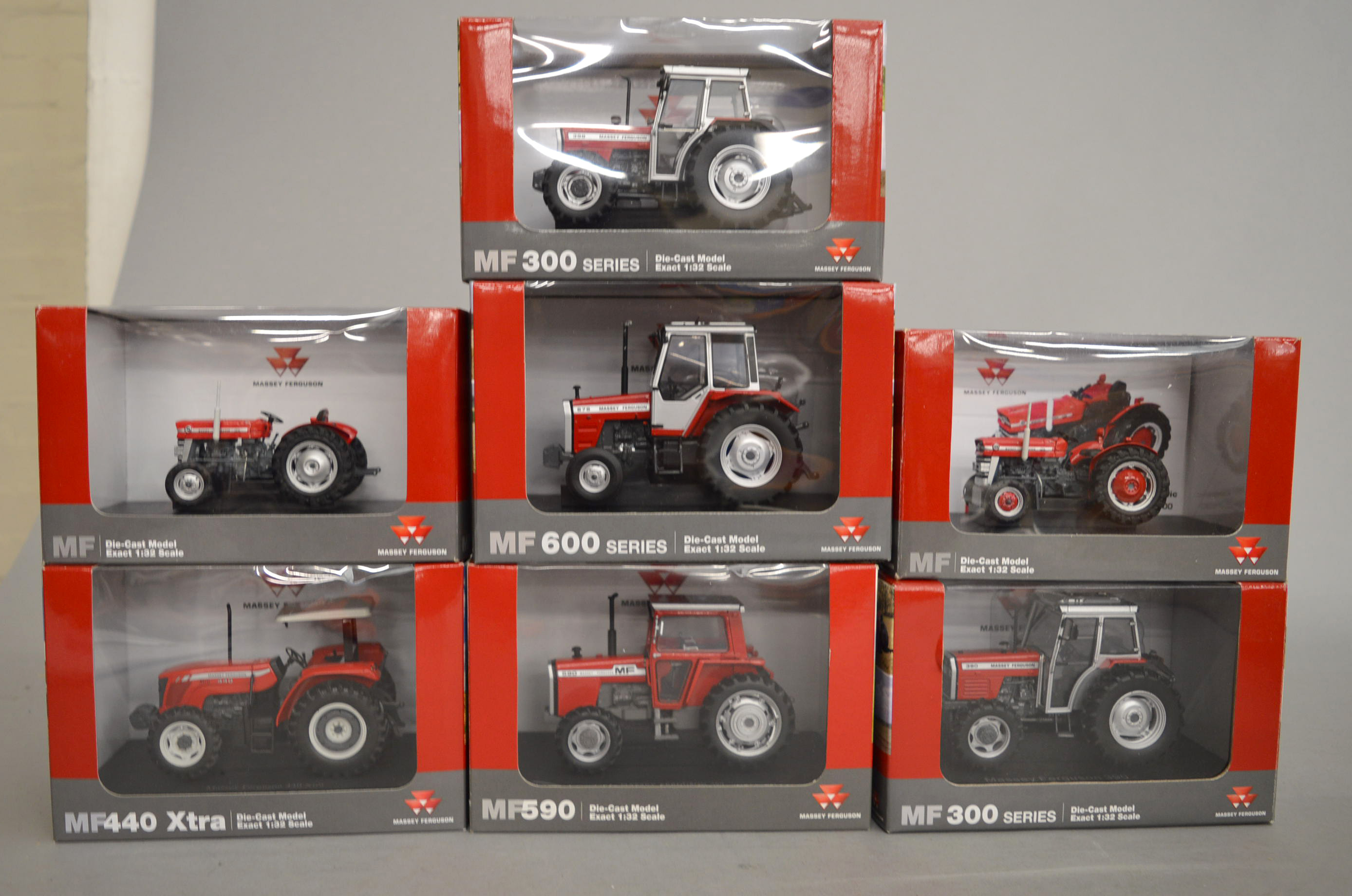 Seven boxed Universal Hobbies diecast model Massey Ferguson Tractors in 1:32 scale.