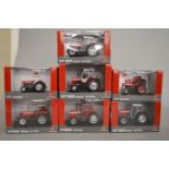 Seven boxed Universal Hobbies diecast model Massey Ferguson Tractors in 1:32 scale.