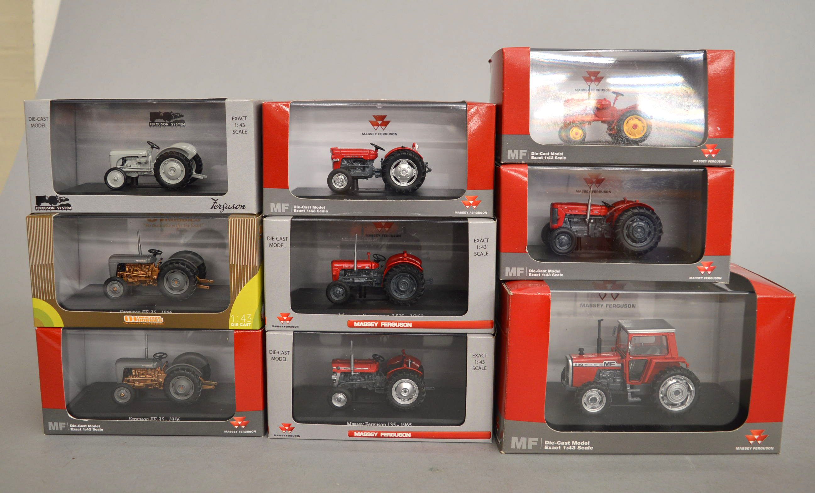 Nine boxed Universal Hobbies diecast model Massey Ferguson Tractors in 1:43 scale.